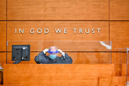 Judge at Bench in front of In God We Trust